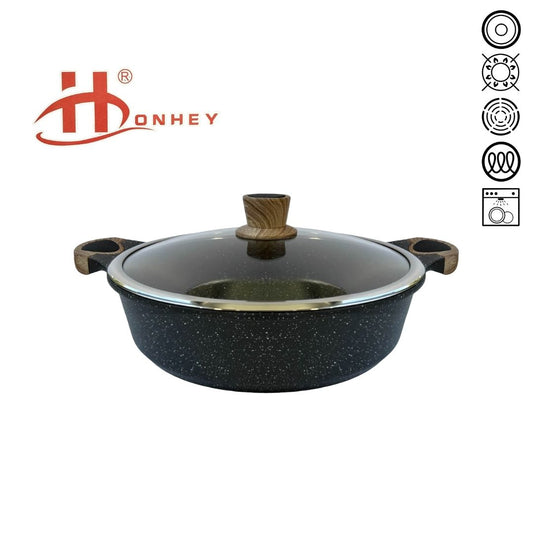 Shallow pot with a black speckled finish, featuring wood-like silicone handles and a clear glass lid, set against a white background.